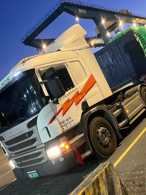 台中港貨櫃碼頭夜間作業，曳引車頭拖運網覆固定貨物